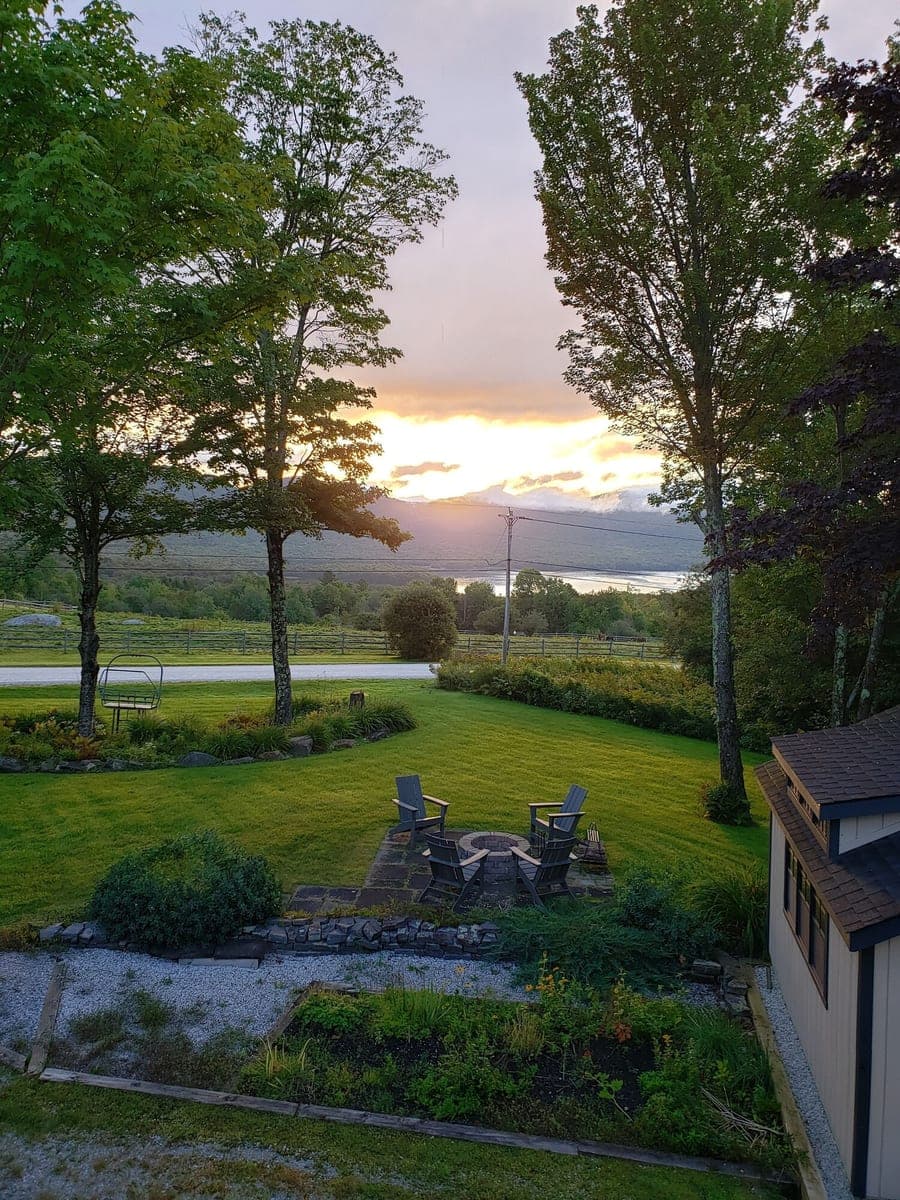 Firepit, lawn, lake, and mountain view at the VRBO