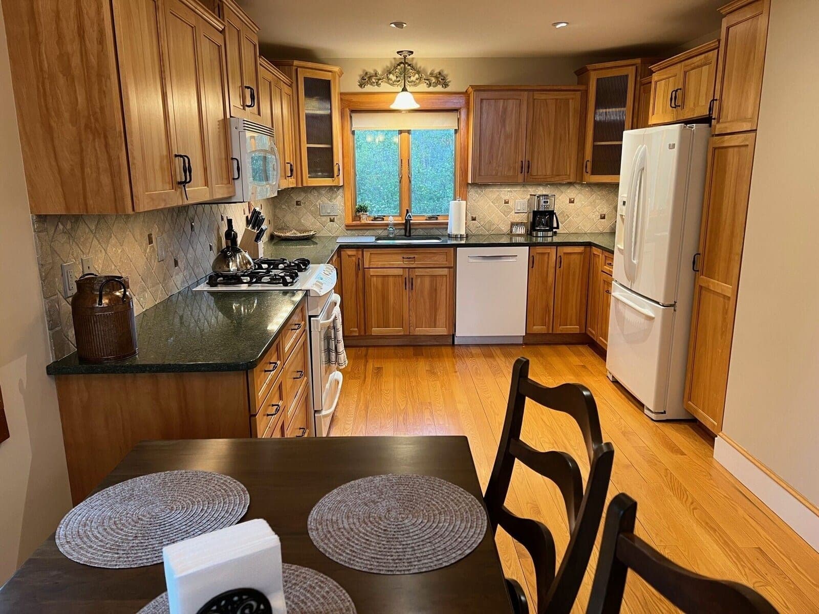 VRBO kitchen with wood cabinetry and modern appliances