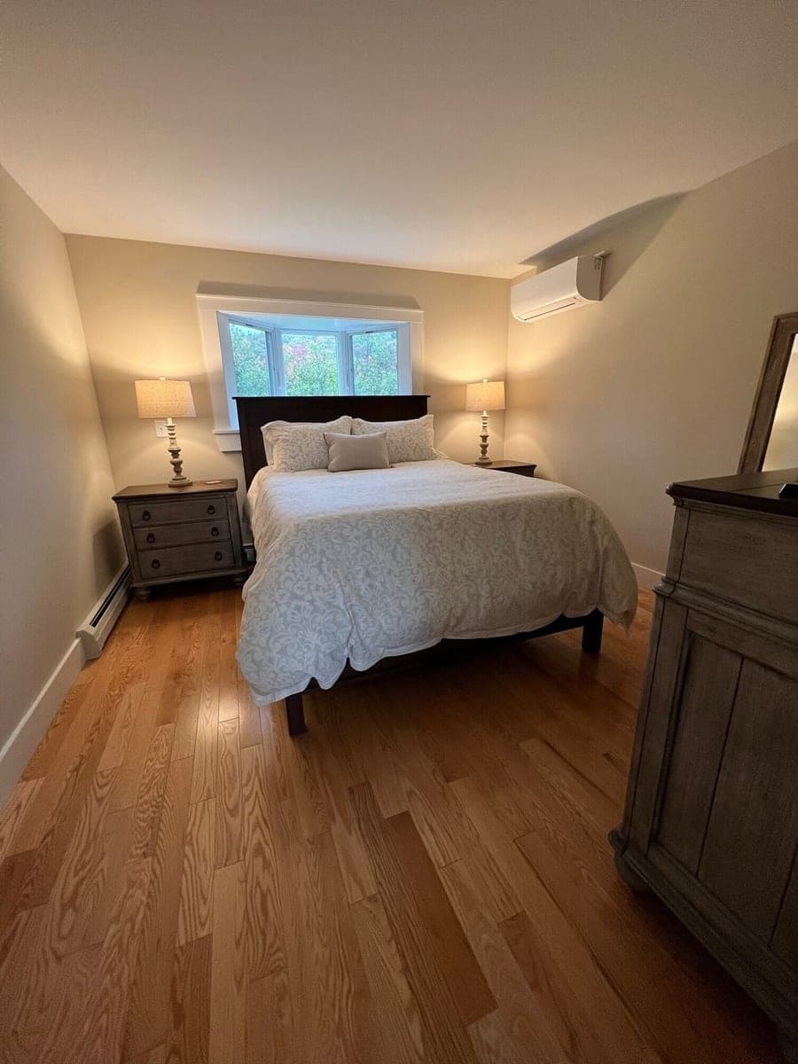 VRBO bedroom with wood floors and bedside lamps