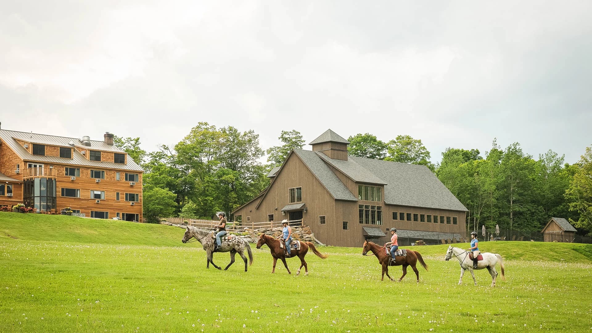 Horseback riders crossing the Mountain Top Resort meadow