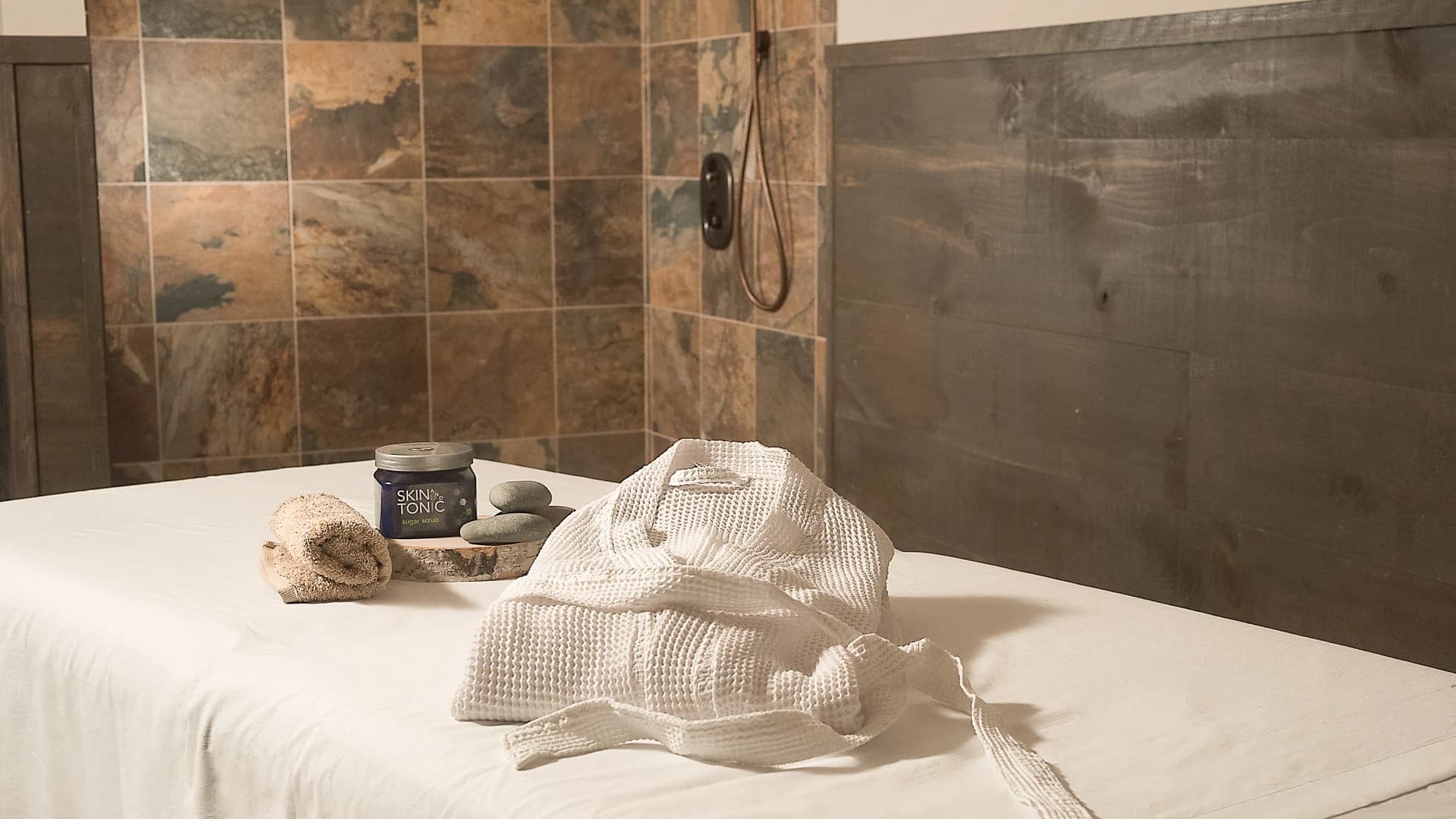 Spa treatment room with robe and stones